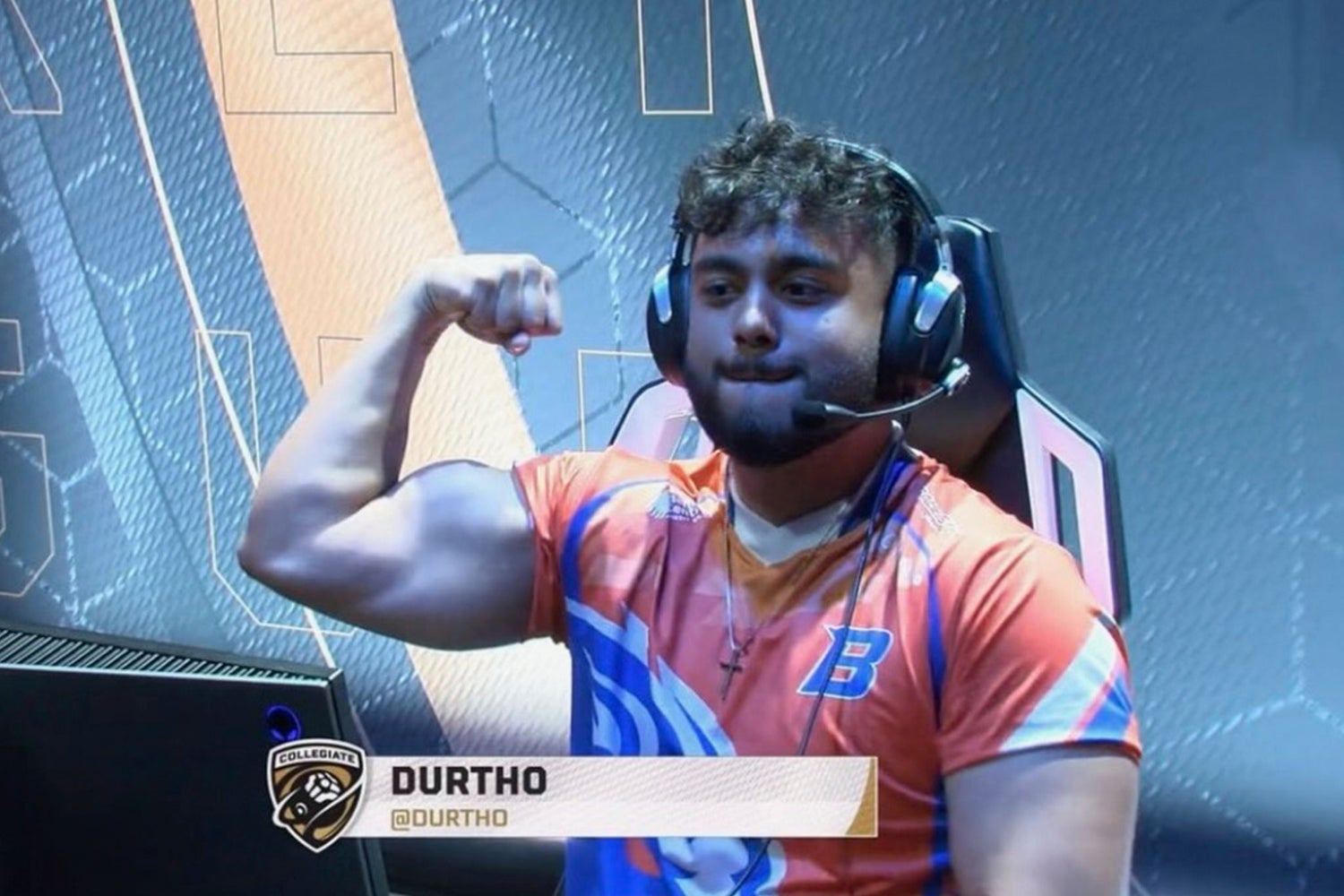 Esports player flexing in gaming setup