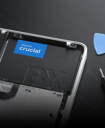 Un SSD Crucial 2,5 pouces posé contre un clavier.