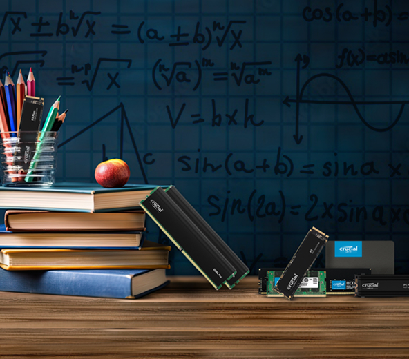 Various Crucial products arranged next to books and pencils in front of a formula board.